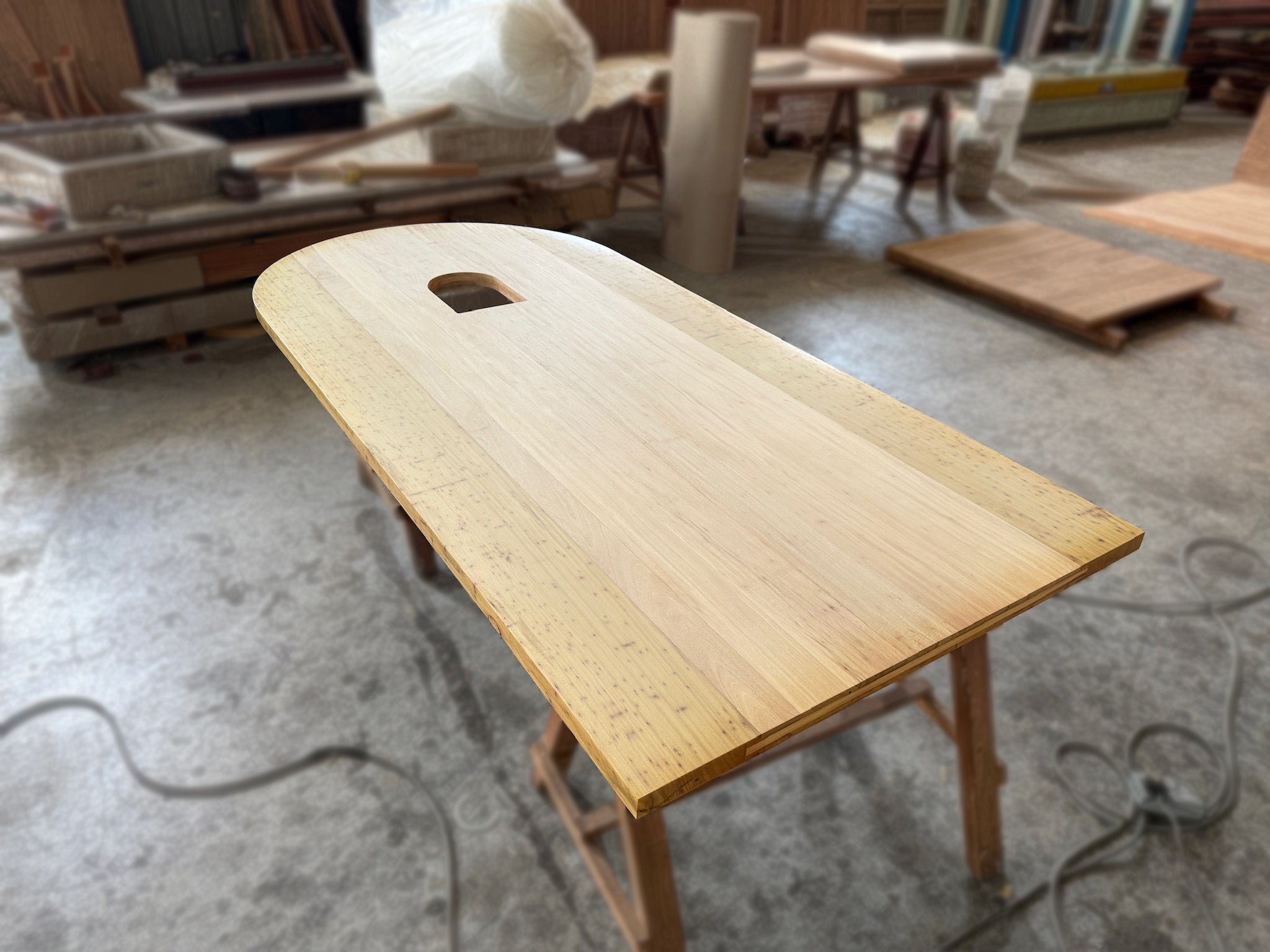 An arch design of full solid chengal hardwood door with customised middle hole design after sanding finished in our factory.