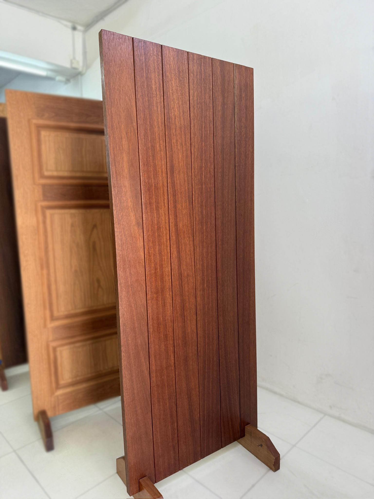 Solid hardwood door made out of nyatoh wood with modern groove lines design and darker stain finished.