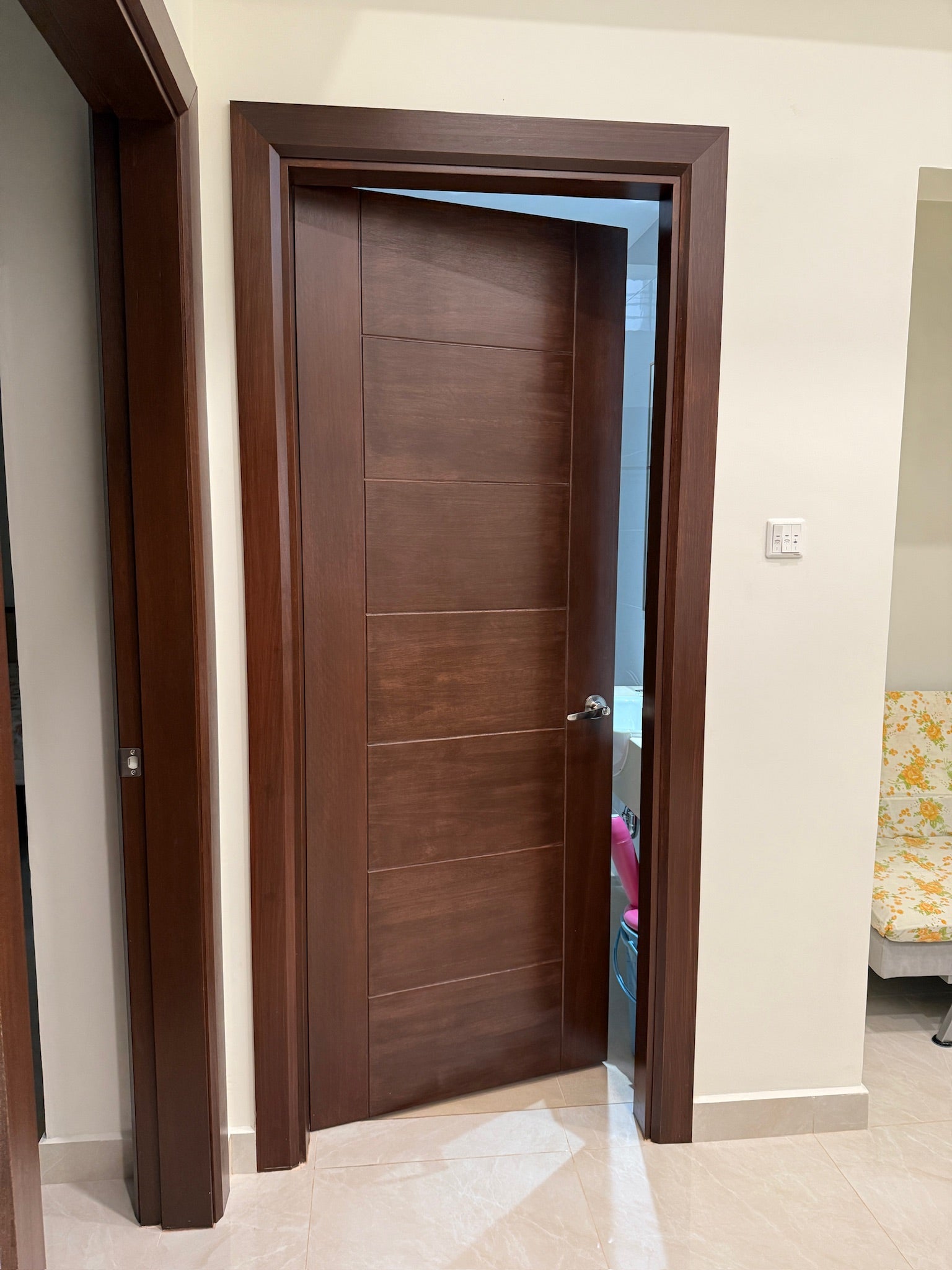 Full solid grade A timber door, frame and architrave with darker stain finished, installed in a house. 