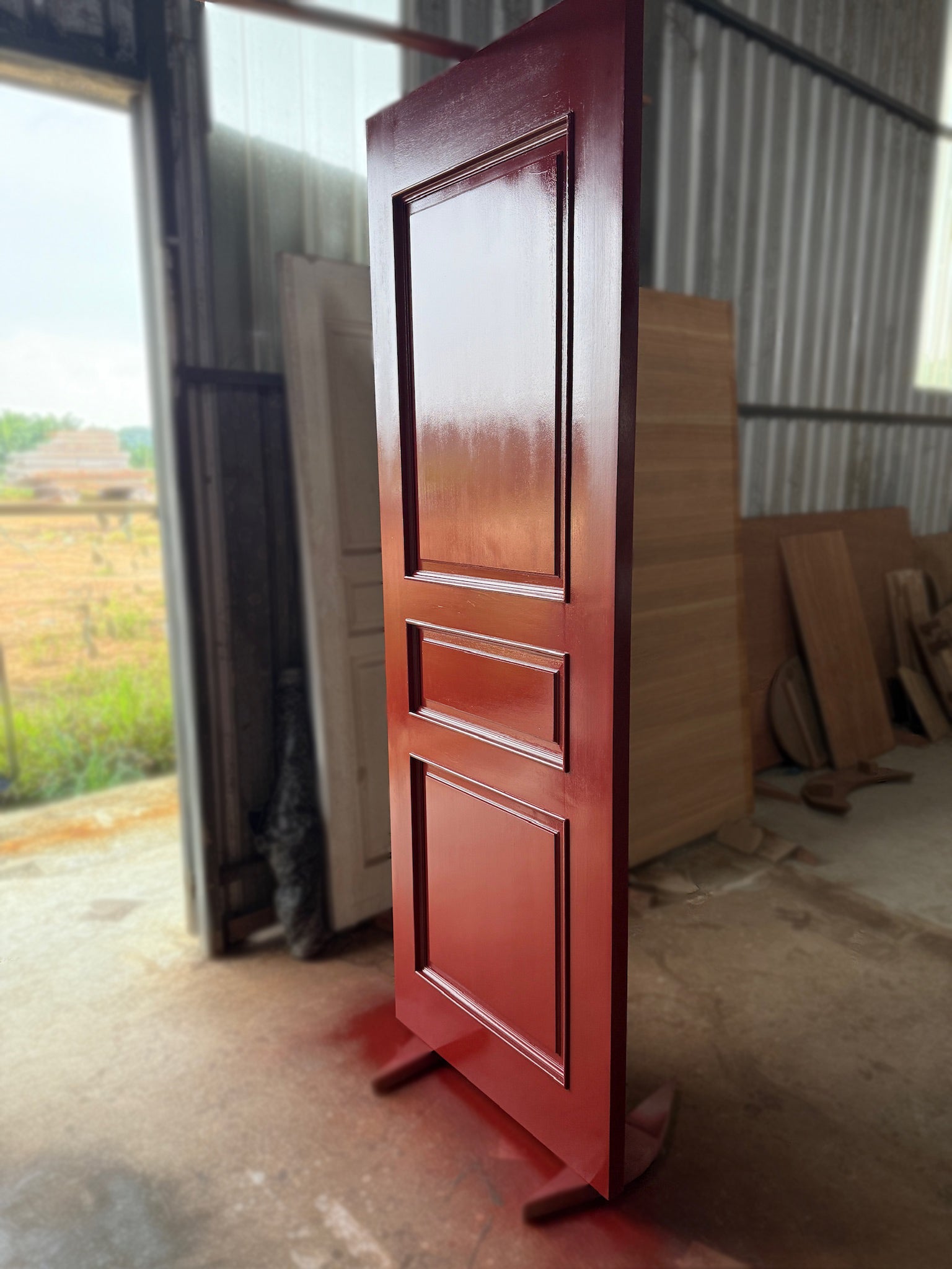 A full solid hardwood door with red paint finished, made from nyatoh wood.