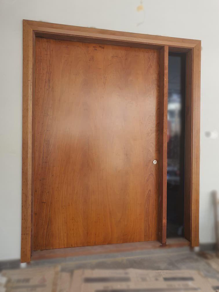 Huge chengal solid pivot door with side glass.