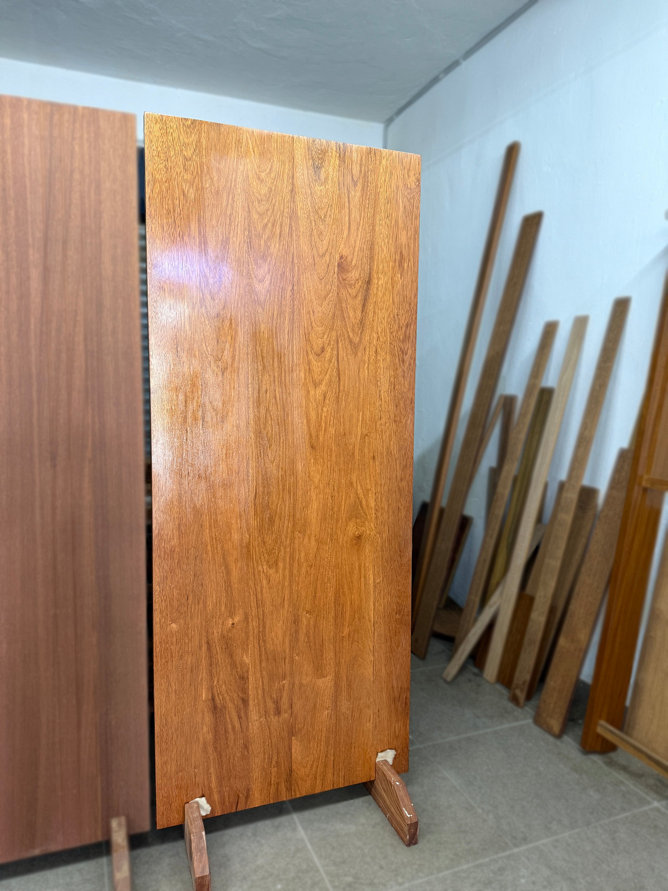 Full solid hardwood door made out of merbau with glossy lacquer finished displaying in a showroom.