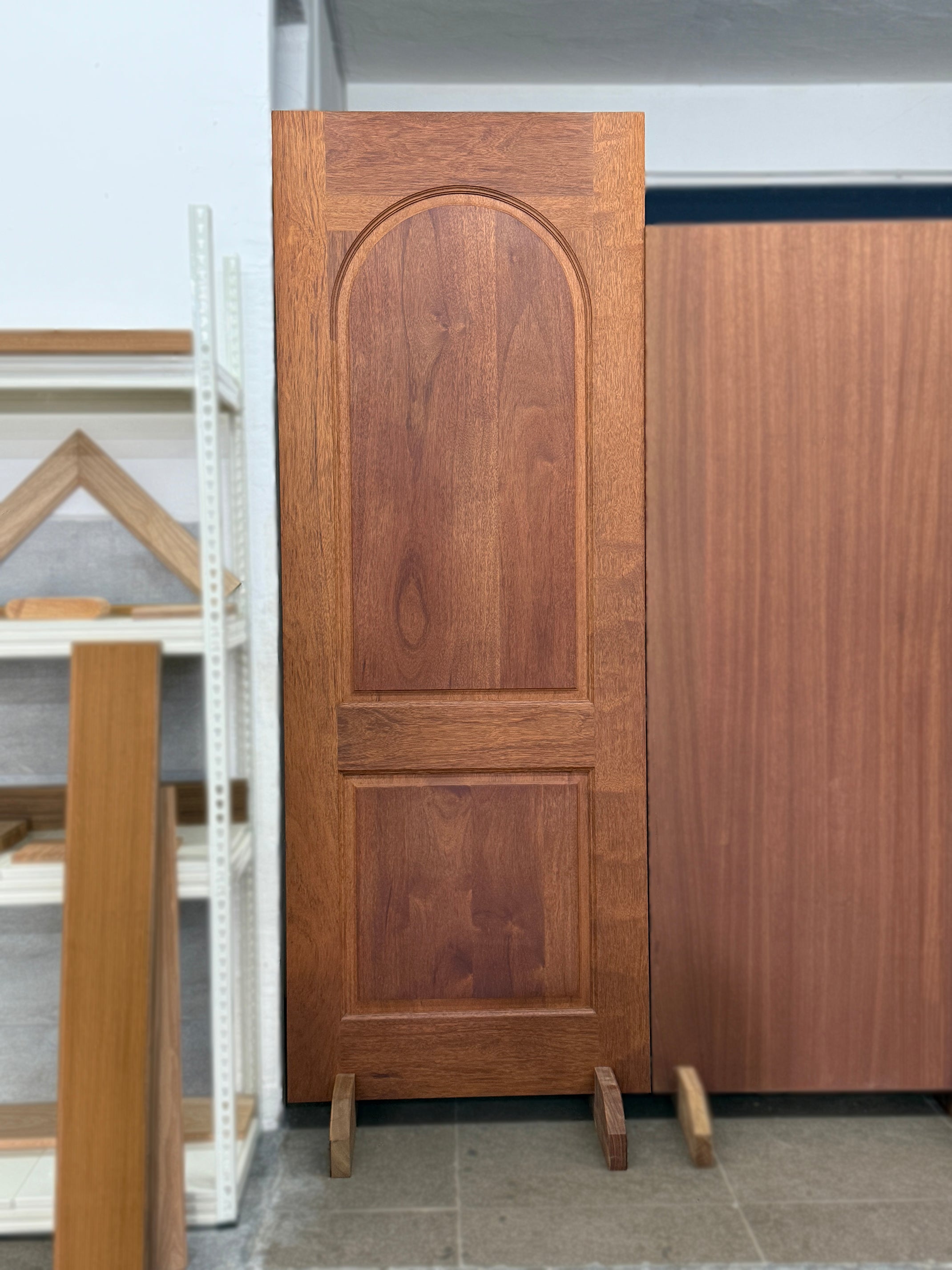 Full solid hardwood door made out of merbau wood displayed in a showroom.