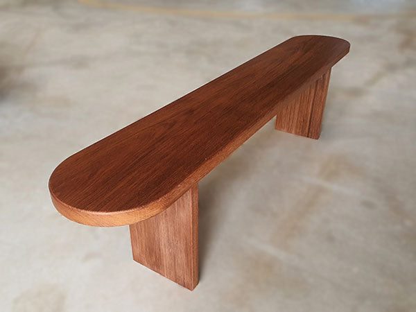 Wooden bench made out of merbau solid hardwood with clear lacquer finished.